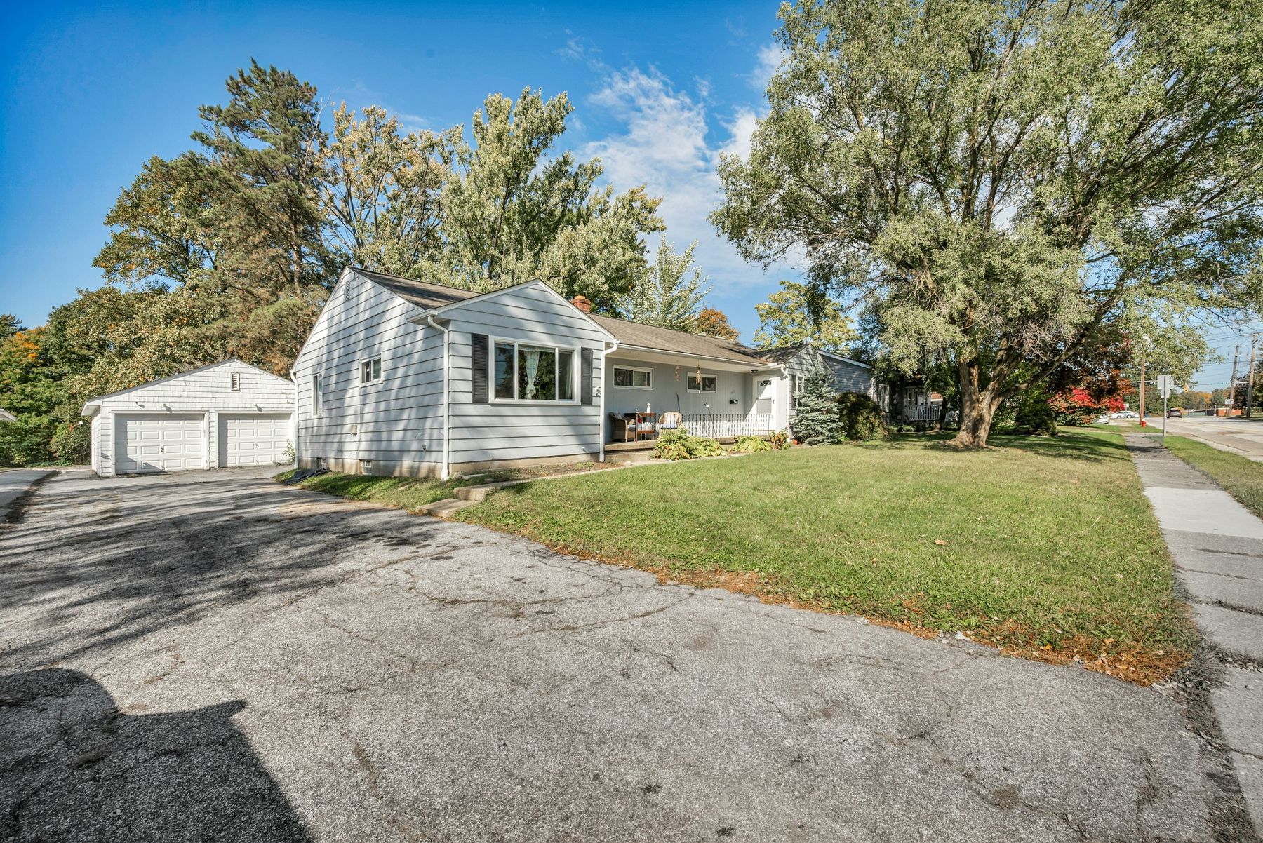 An asphalt driveway beside a house