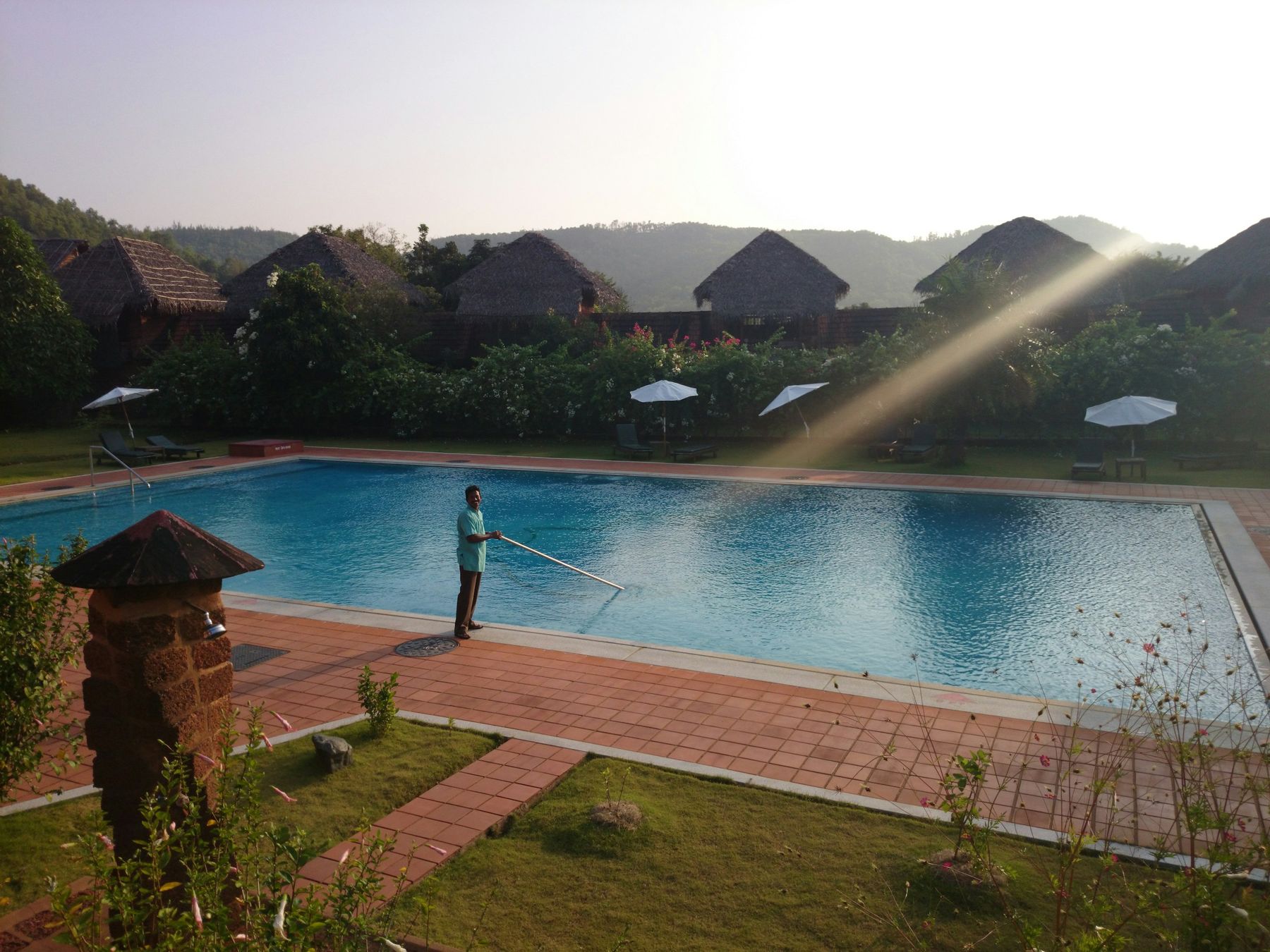 A pro cleaning a pool